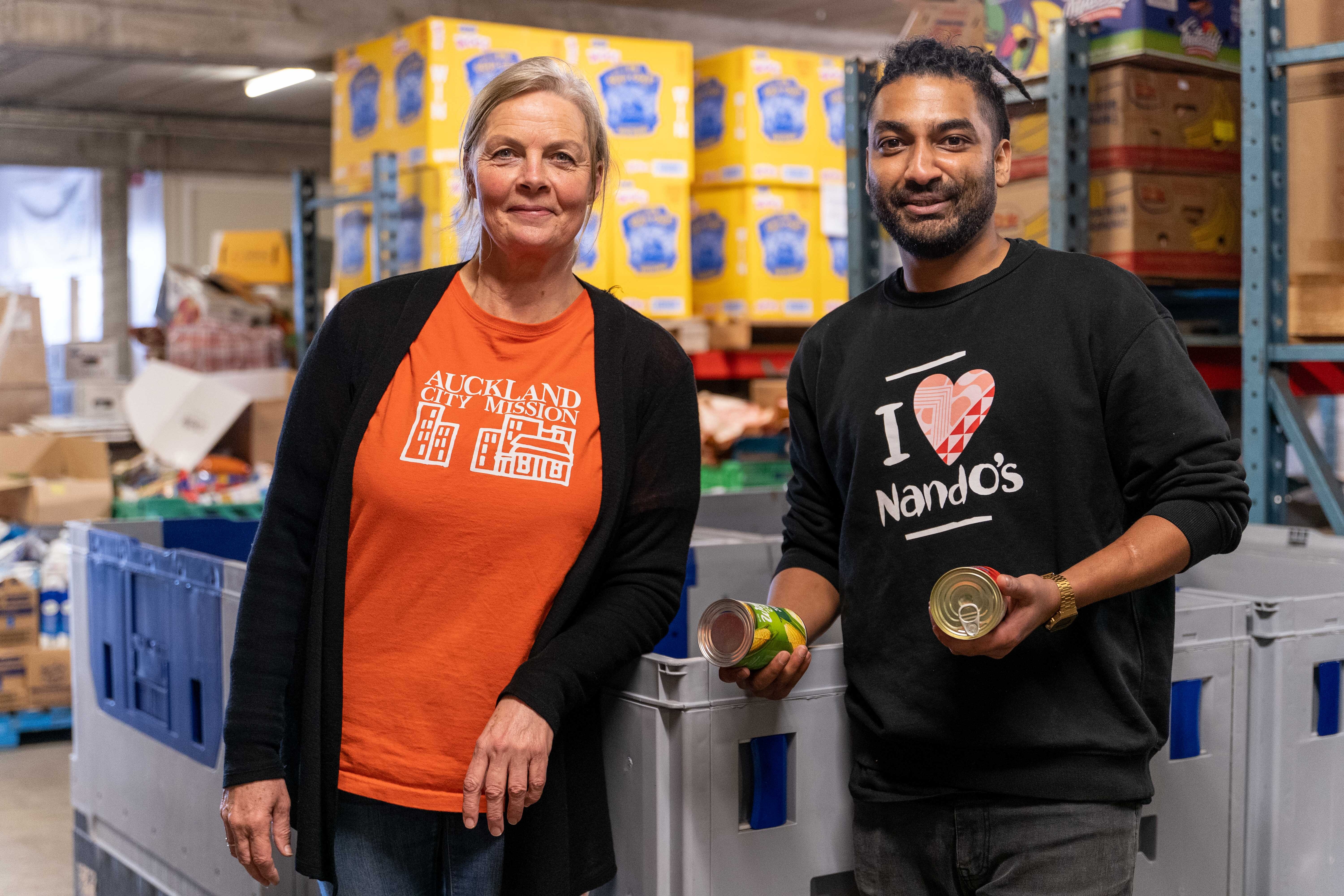 Auckland City Mission staff member and Nando's staff member at the Mission's distribution centre.